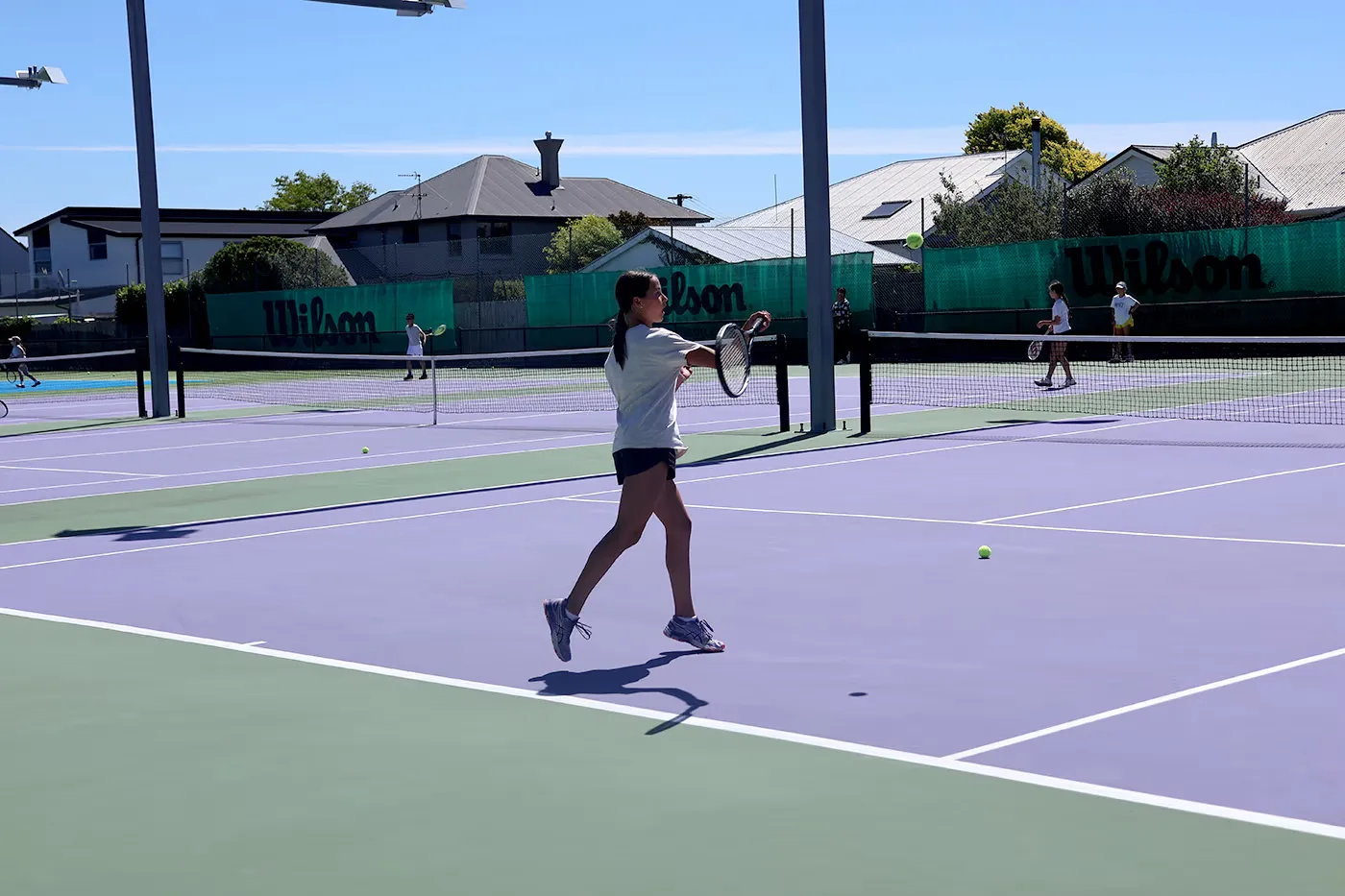 A young player training on court at the Waimairi Tennis Club - great forehand!