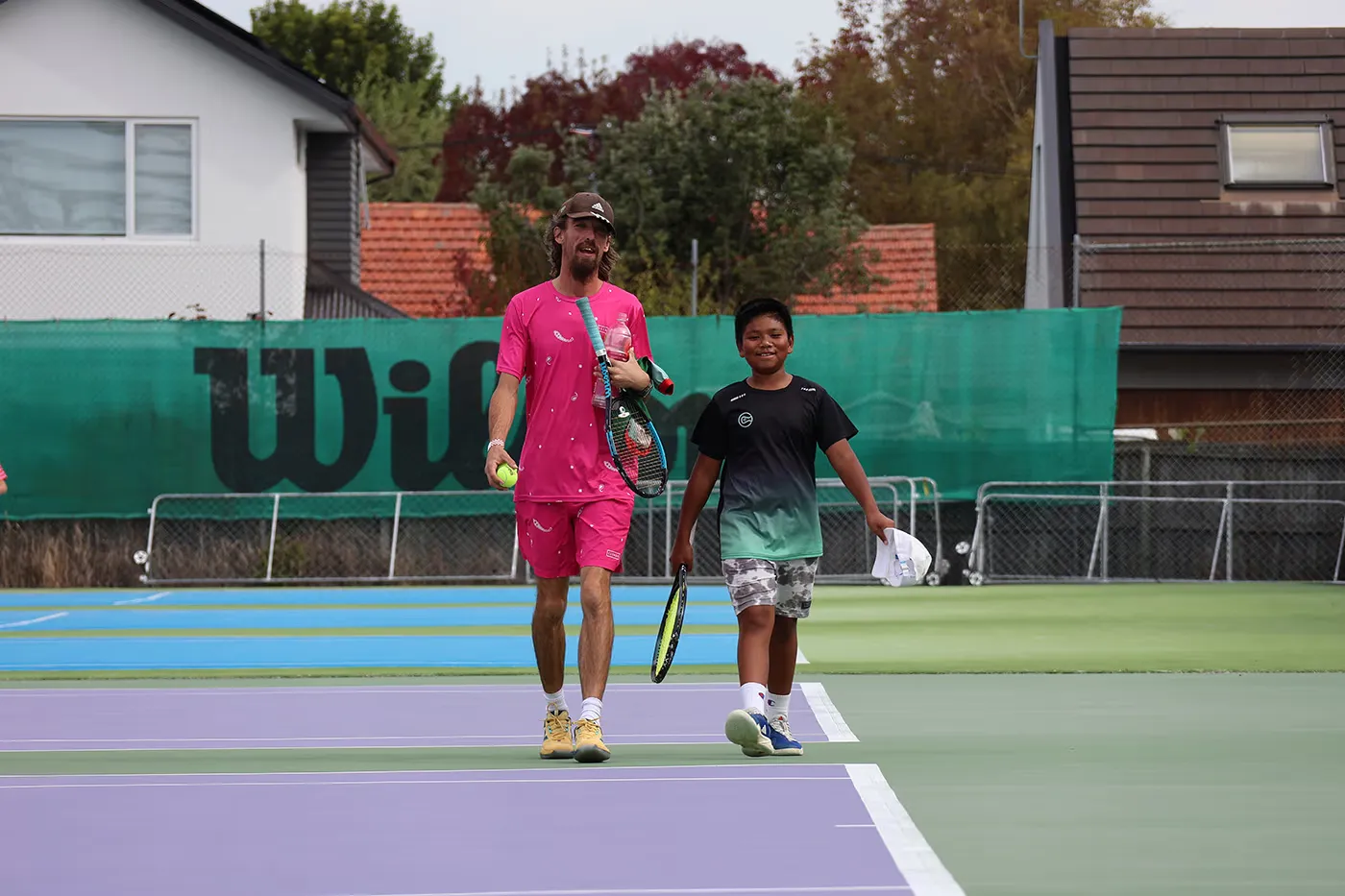 2 players walking on a tennis court after a solid training session